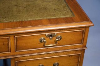 Traditional brass, swan neck pulls adorn the drawer fronts.