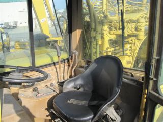 Runs good, looks clean. Has a complete enclosed cab with attached A/C